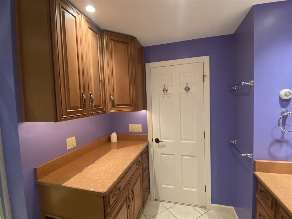 5 Ryan Road, Unit A Gloucester, MA 01930 - Photo 22 of 28 a bathroom with a granite countertop sink and a mirror