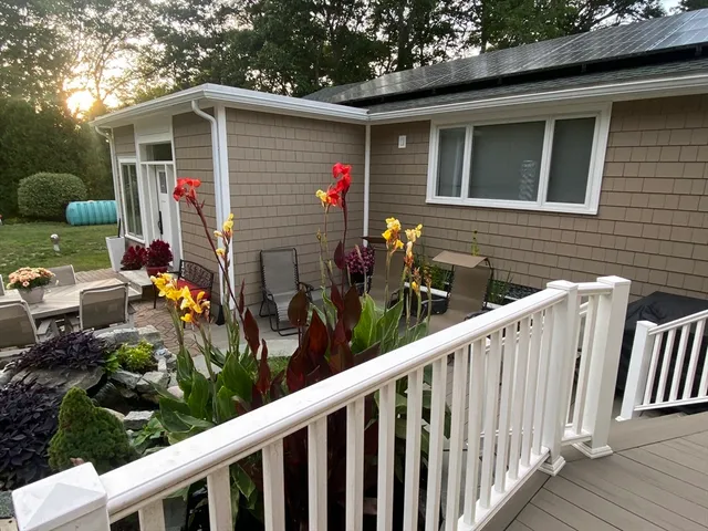 a front view of a house with cars parked