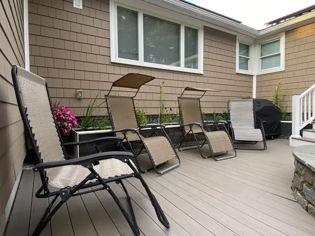 a view of a patio with couches table and chairs and potted plants