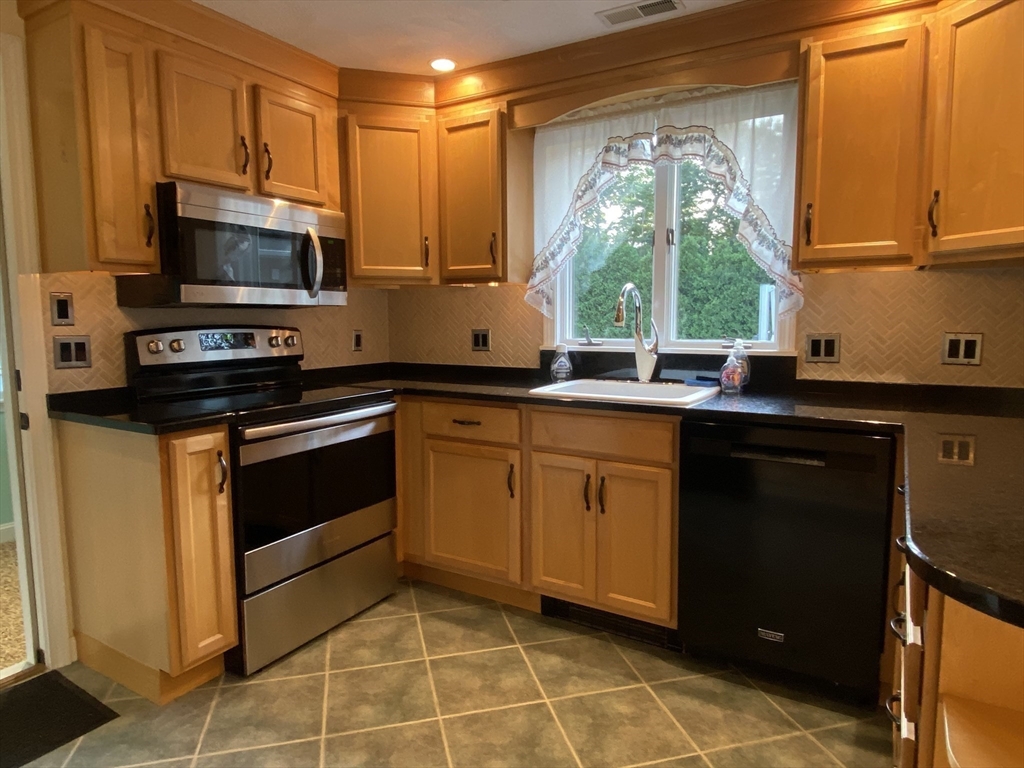 5 Ryan Road, Unit A Gloucester, MA 01930 - Photo 8 of 28 a kitchen with a sink stove and microwave