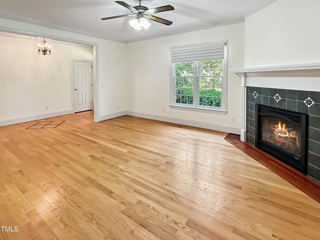 a kitchen with stainless steel appliances granite countertop a dining table chairs and a refrigerator