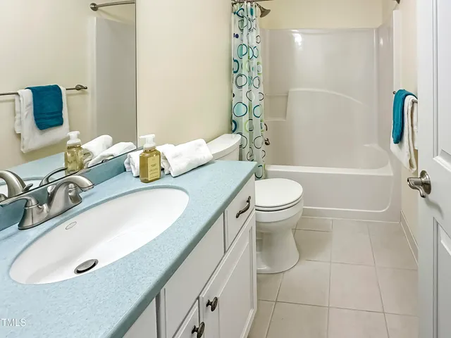 a bathroom with cabinets and mirror