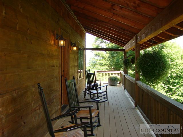 484 Gable Farm Road Boone, NC 28607 - Photo 18 of 27 a view of a chairs and table in patio with wooden floor