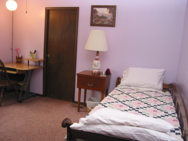 64 Eastfield Road Montgomery, IL 60538 - Photo 14 of 22 a bedroom with a bed and a table in it