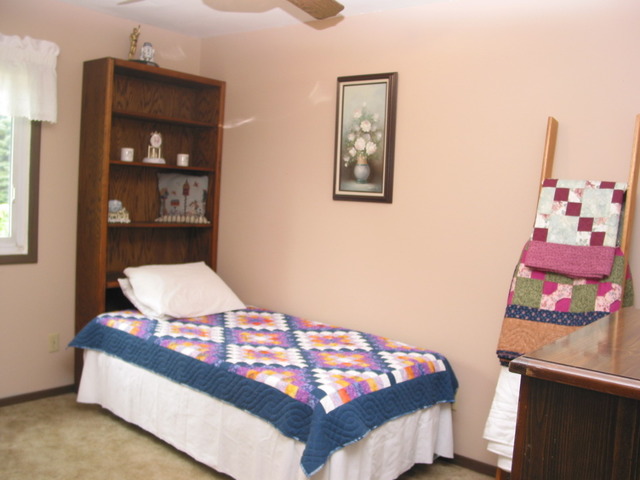 64 Eastfield Road Montgomery, IL 60538 - Photo 15 of 22 a bedroom with a bed and wooden floor