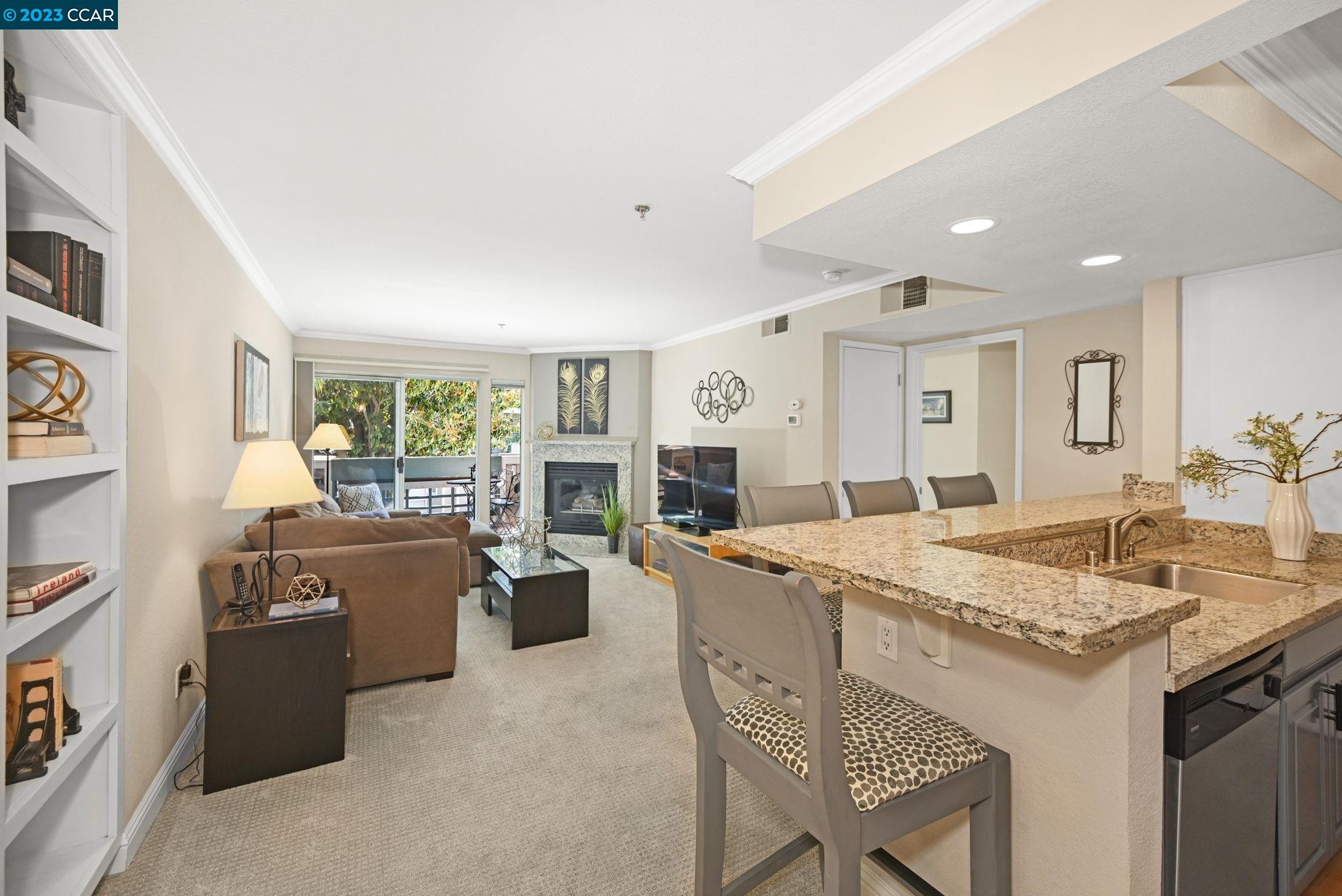 2560 Oak Road, Unit 221 Walnut Creek, CA 94597 - Photo 1 of 1 a open kitchen with stainless steel appliances granite countertop a stove top oven a sink dishwasher and a dining table with wooden floor