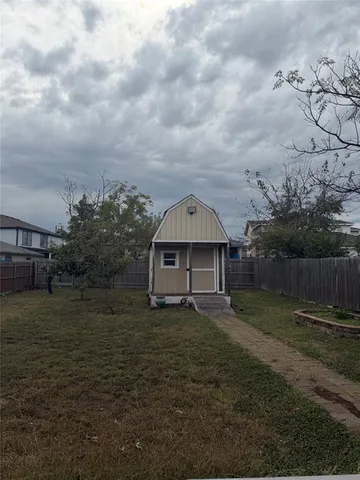 a view of a small house with a yard