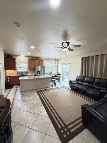 a living room with furniture and kitchen view