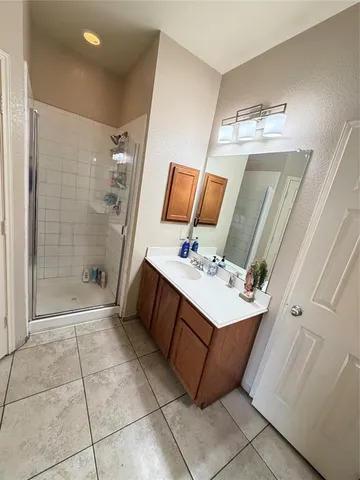 a bathroom with a sink a mirror and shower