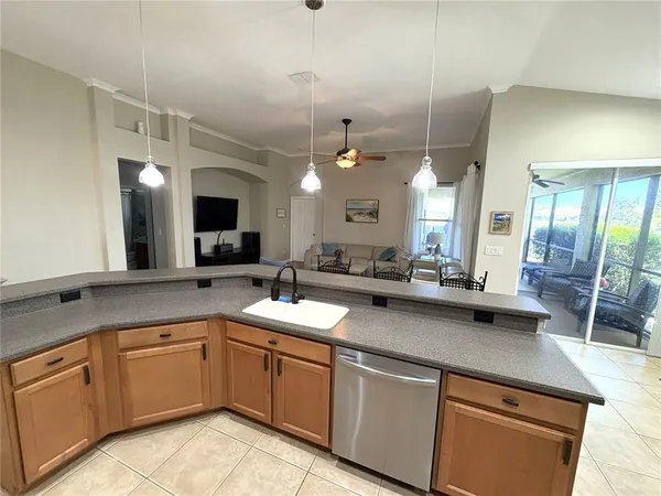 a large kitchen with a sink and cabinets