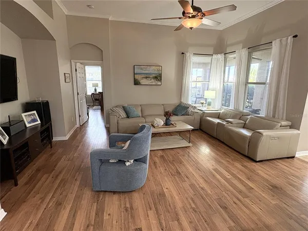a living room with furniture and a wooden floor