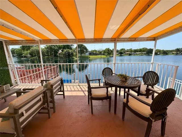 a view of a chairs and table in patio