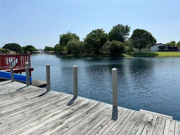 a view of a balcony with furniture and a lake view