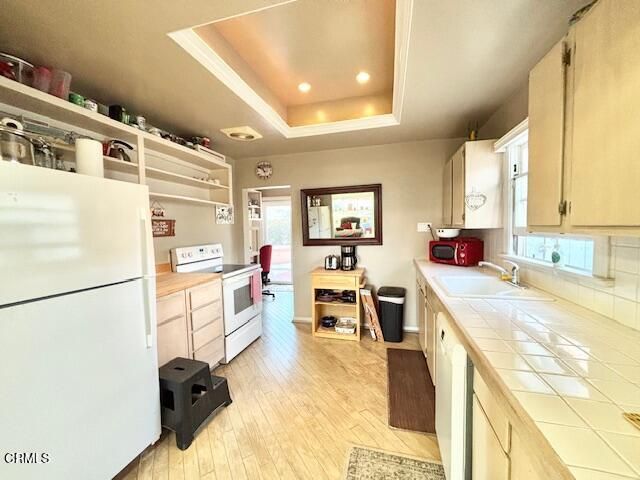 a large white kitchen with cabinets