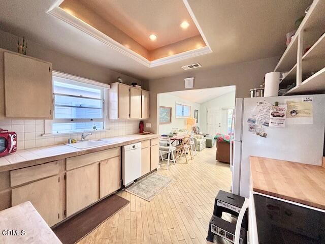 a large white kitchen with cabinets