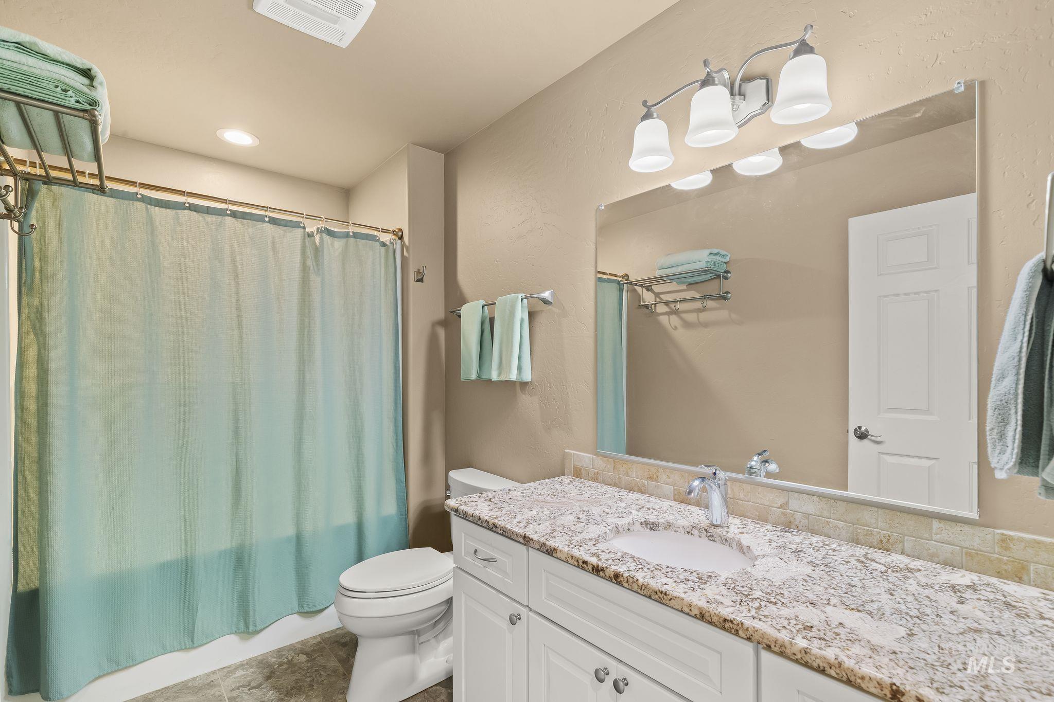 435 River Pointe Lane Lenore, ID 83541 - Photo 24 of 50 Bedroom featuring twin beds, carpet flooring, a ceiling-mounted light fixture, and two large windows with outdoor scenery