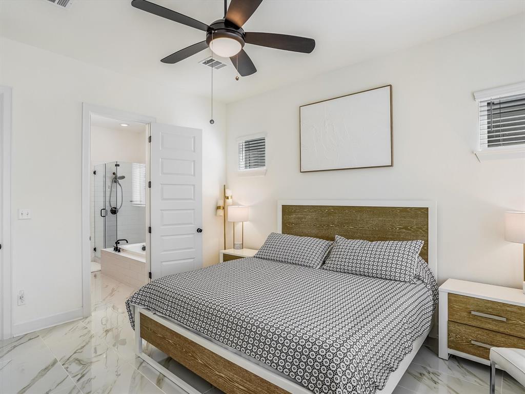 889 Hazy Hills Loop Dripping Springs, TX 78620 - Photo 10 of 20 Bedroom with light marble finish flooring, a ceiling fan, and ensuite bath