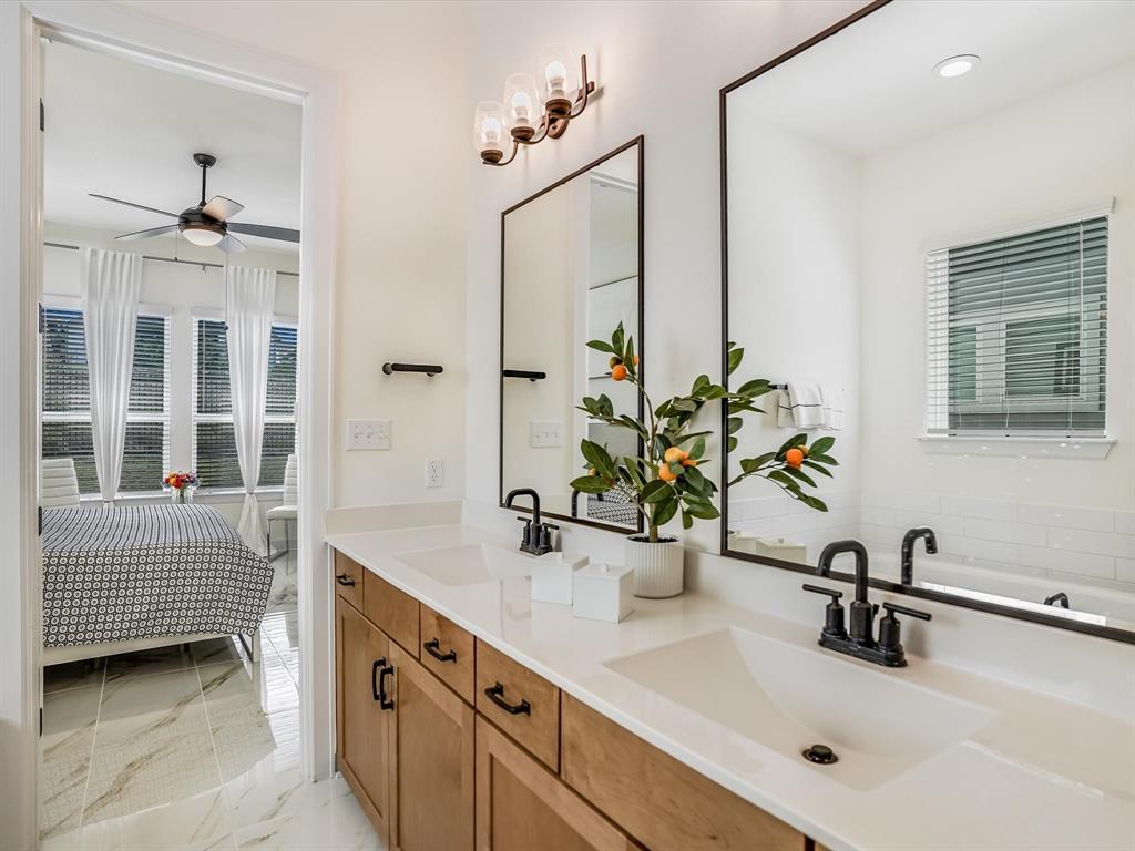 889 Hazy Hills Loop Dripping Springs, TX 78620 - Photo 11 of 20 Ensuite bathroom featuring double vanity, light marble finish floors, and a ceiling fan