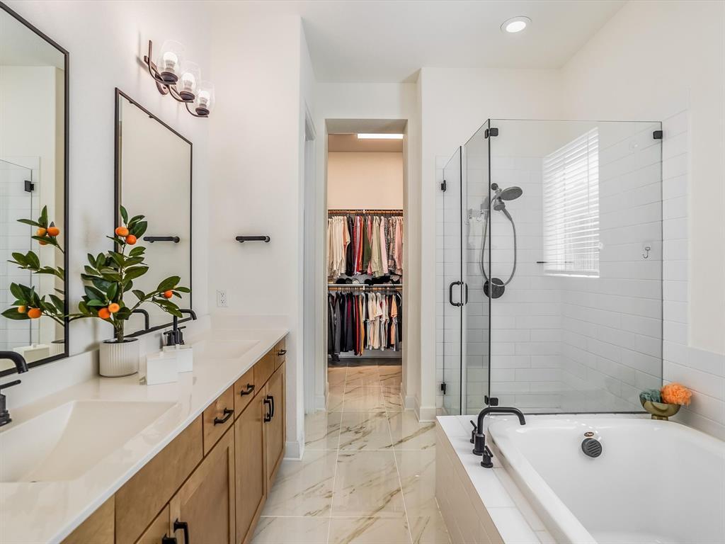 889 Hazy Hills Loop Dripping Springs, TX 78620 - Photo 12 of 20 Full bathroom featuring double vanity, a spacious closet, a stall shower, and a bath