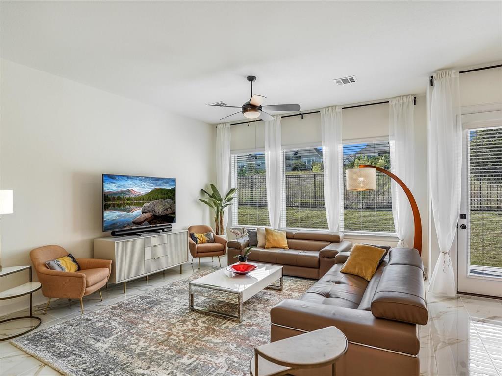 889 Hazy Hills Loop Dripping Springs, TX 78620 - Photo 8 of 20 Living room featuring ceiling fan and marble finish flooring