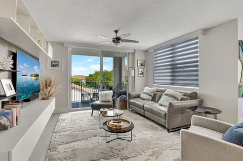 a living room with furniture a rug and a flat screen tv