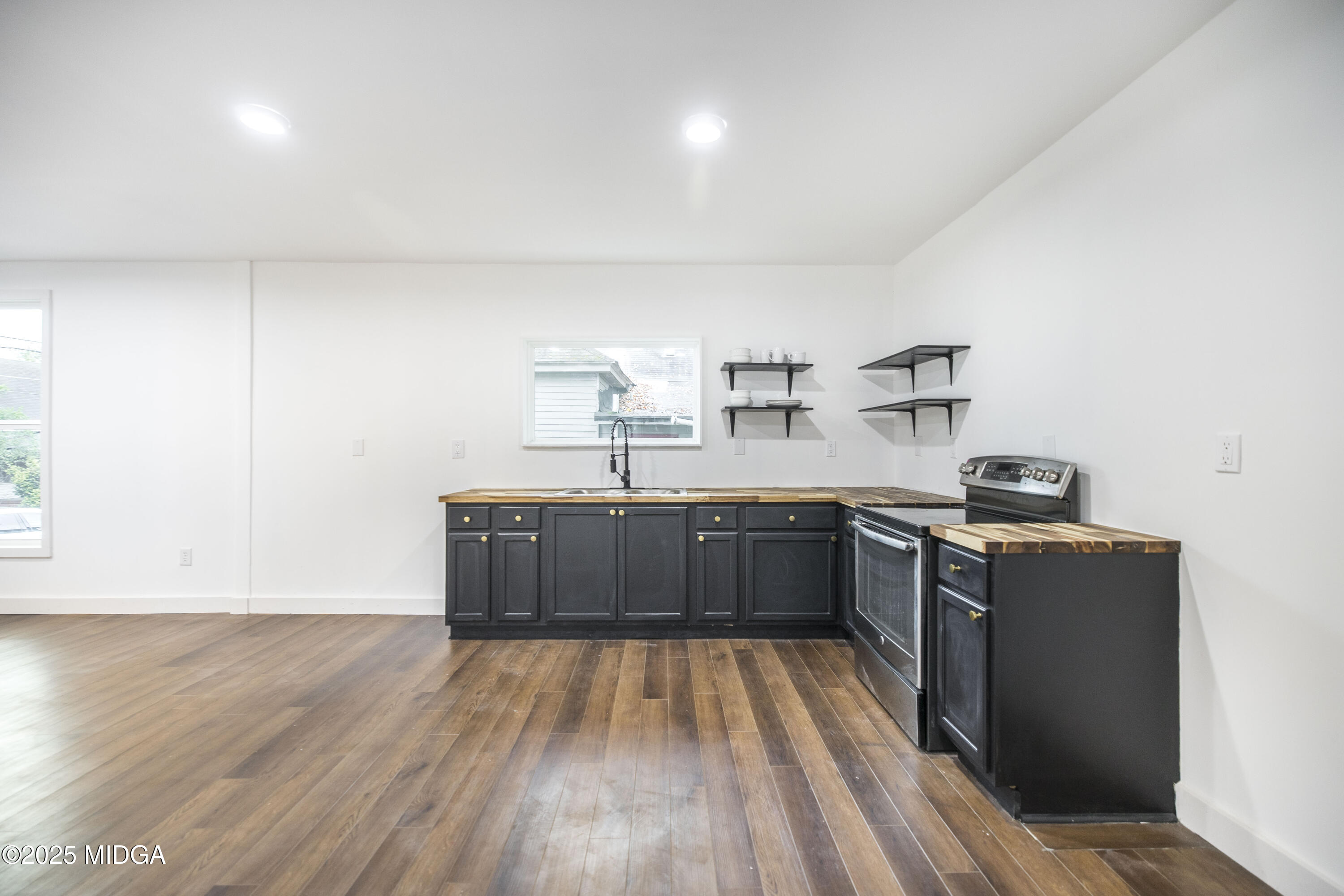 335 Lincoln Avenue Macon, GA 31201 - Photo 8 of 20 a kitchen with stainless steel appliances granite countertop a stove a sink and a refrigerator