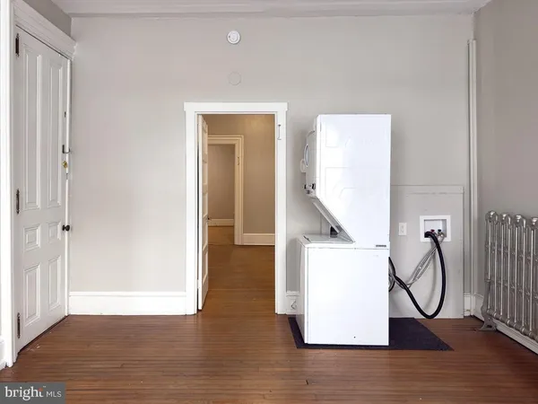a view of a room with wooden floor and windows