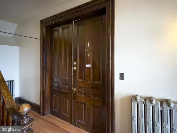 a view of a hallway with wooden floor