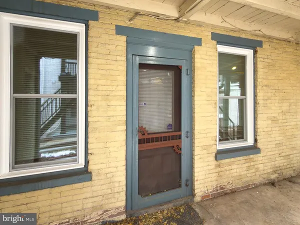 a view of a door of the house and a outdoor space