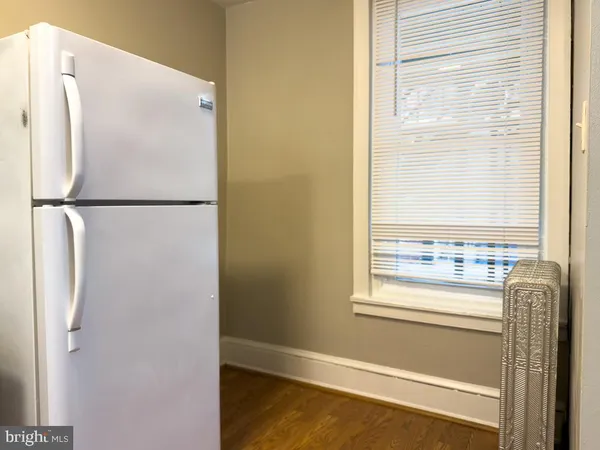 a view of a kitchen with a refrigerator and a window