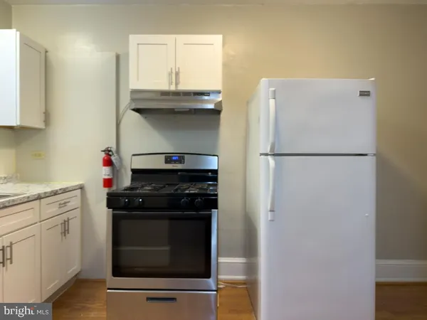 a kitchen with a stove and a refrigerator