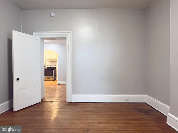 a view of a room with wooden floor and a sink