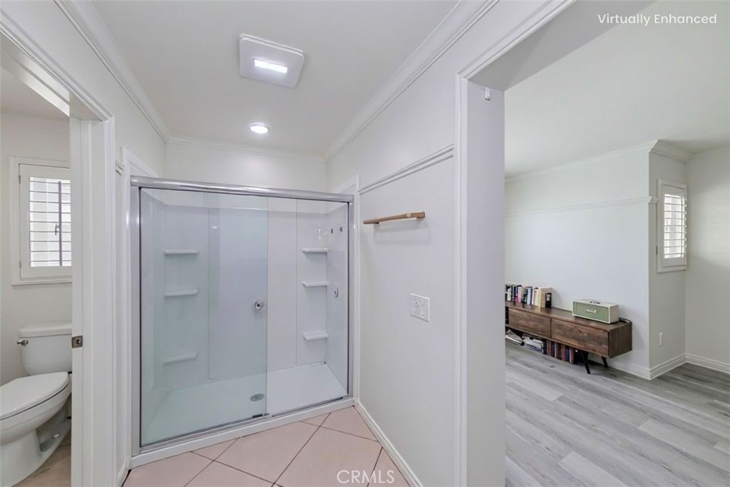 5010 Golondrina Way, Unit 64 Oceanside, CA 92057 - Photo 14 of 31 a view of a bathroom from a hallway and a livingroom with furniture