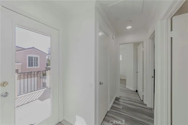 a view of a hallway with wooden floor and entryway