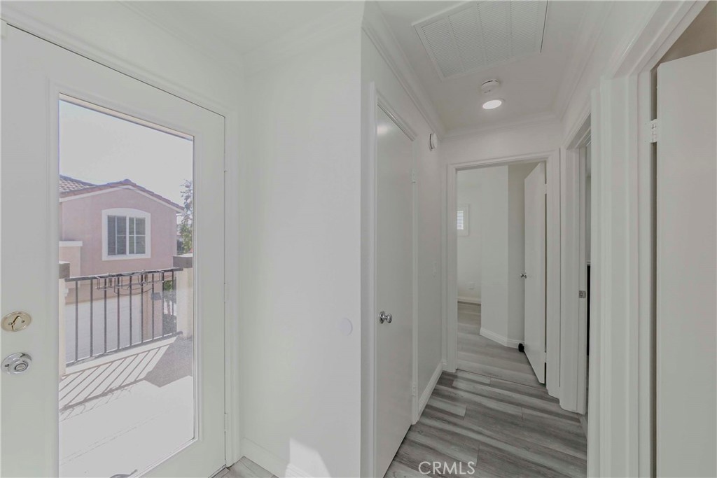 5010 Golondrina Way, Unit 64 Oceanside, CA 92057 - Photo 15 of 31 a view of a hallway with wooden floor and entryway