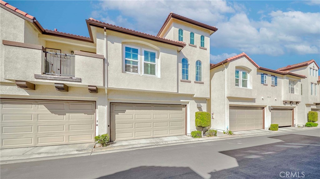 5010 Golondrina Way, Unit 64 Oceanside, CA 92057 - Photo 22 of 31 a front view of a house with a parking area