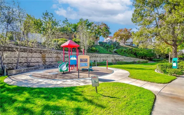 a childrens park with lots of swings and slides