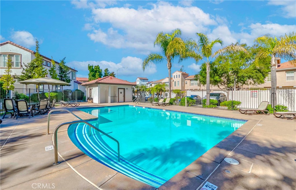 5010 Golondrina Way, Unit 64 Oceanside, CA 92057 - Photo 28 of 31 a view of a house with a swimming pool and a chairs