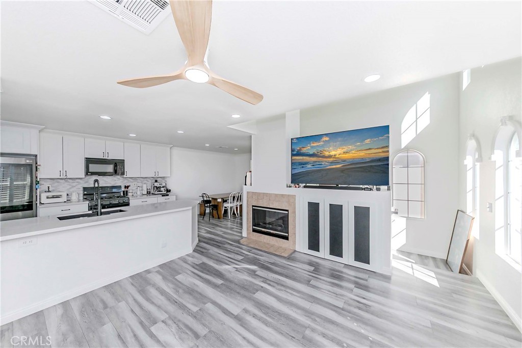 5010 Golondrina Way, Unit 64 Oceanside, CA 92057 - Photo 5 of 31 a living room with stainless steel appliances furniture and a flat screen tv