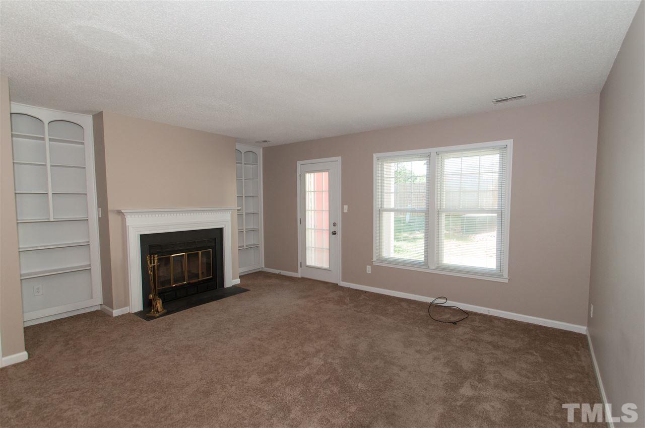 3312 Comstock Road Raleigh, NC 27604 - Photo 3 of 14 an empty room with windows and fireplace