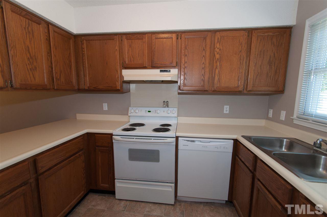 3312 Comstock Road Raleigh, NC 27604 - Photo 8 of 14 a kitchen with a sink stove and cabinets