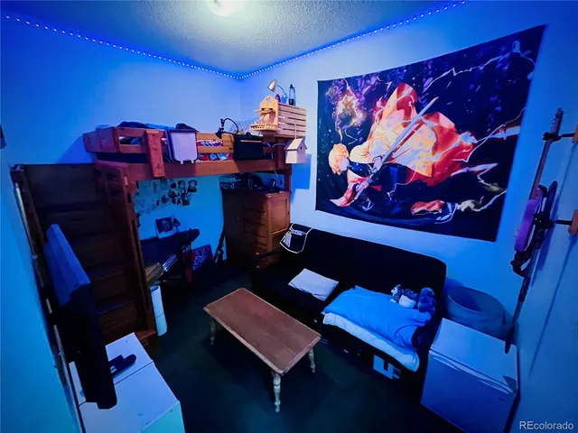 a living room with furniture and a lamp