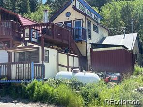 104 Utica Street Ward, CO 80481 - Photo 2 of 13 a front view of a house with garden