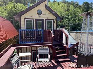 104 Utica Street Ward, CO 80481 - Photo 3 of 13 a view of a chair and table in the balcony