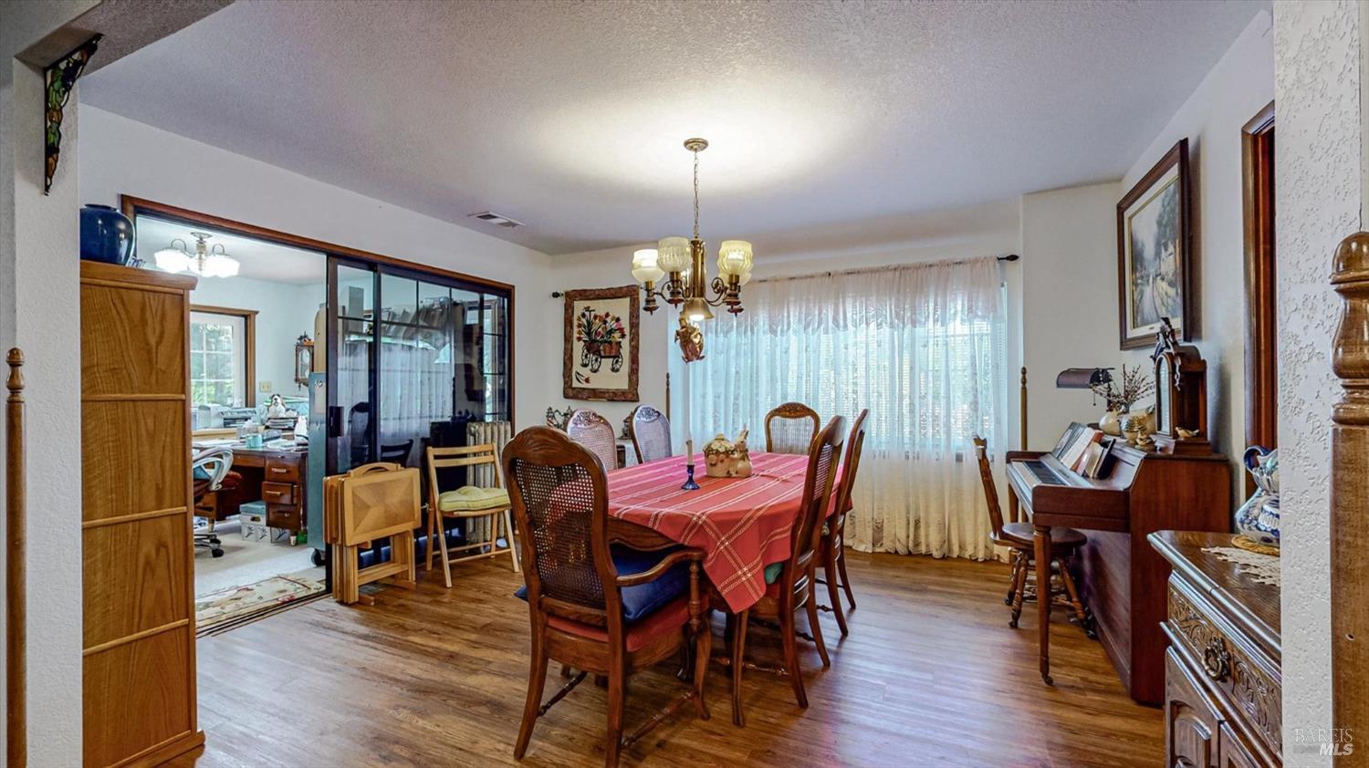3535 Patricks Point Drive Trinidad, CA 95570 - Photo 20 of 61 a dining room with furniture a chandelier and wooden floor