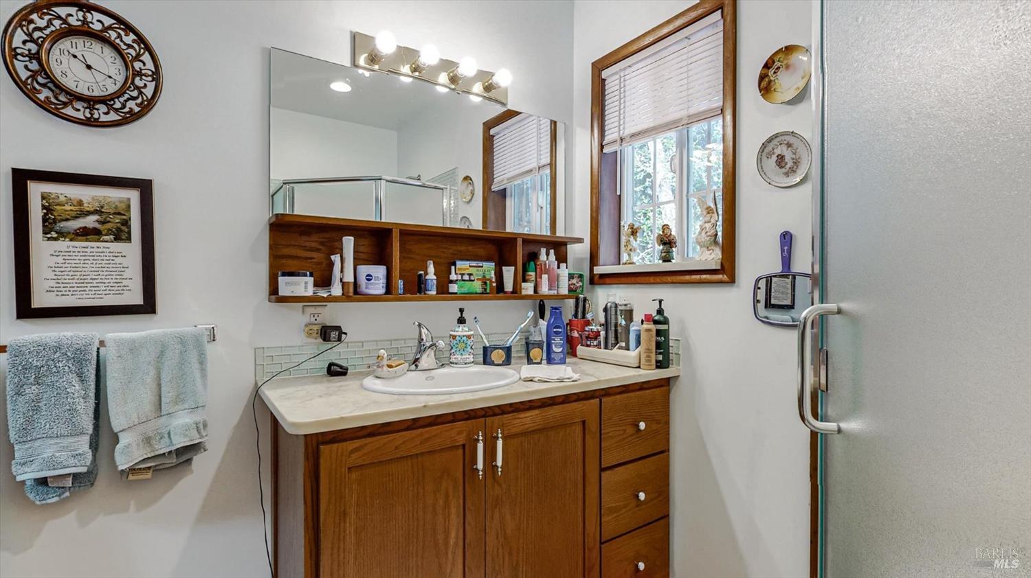 3535 Patricks Point Drive Trinidad, CA 95570 - Photo 33 of 61 a bathroom with a sink a mirror and a clock on the wall