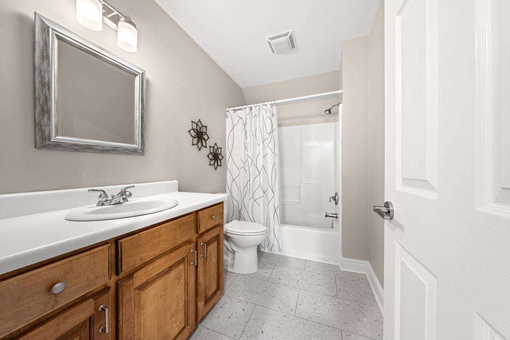 217 Maret Road Townville, SC 29689 - Photo 25 of 35 A well-appointed bathroom with a spacious vanity, framed mirror, and clean-lined shower-tub combination.