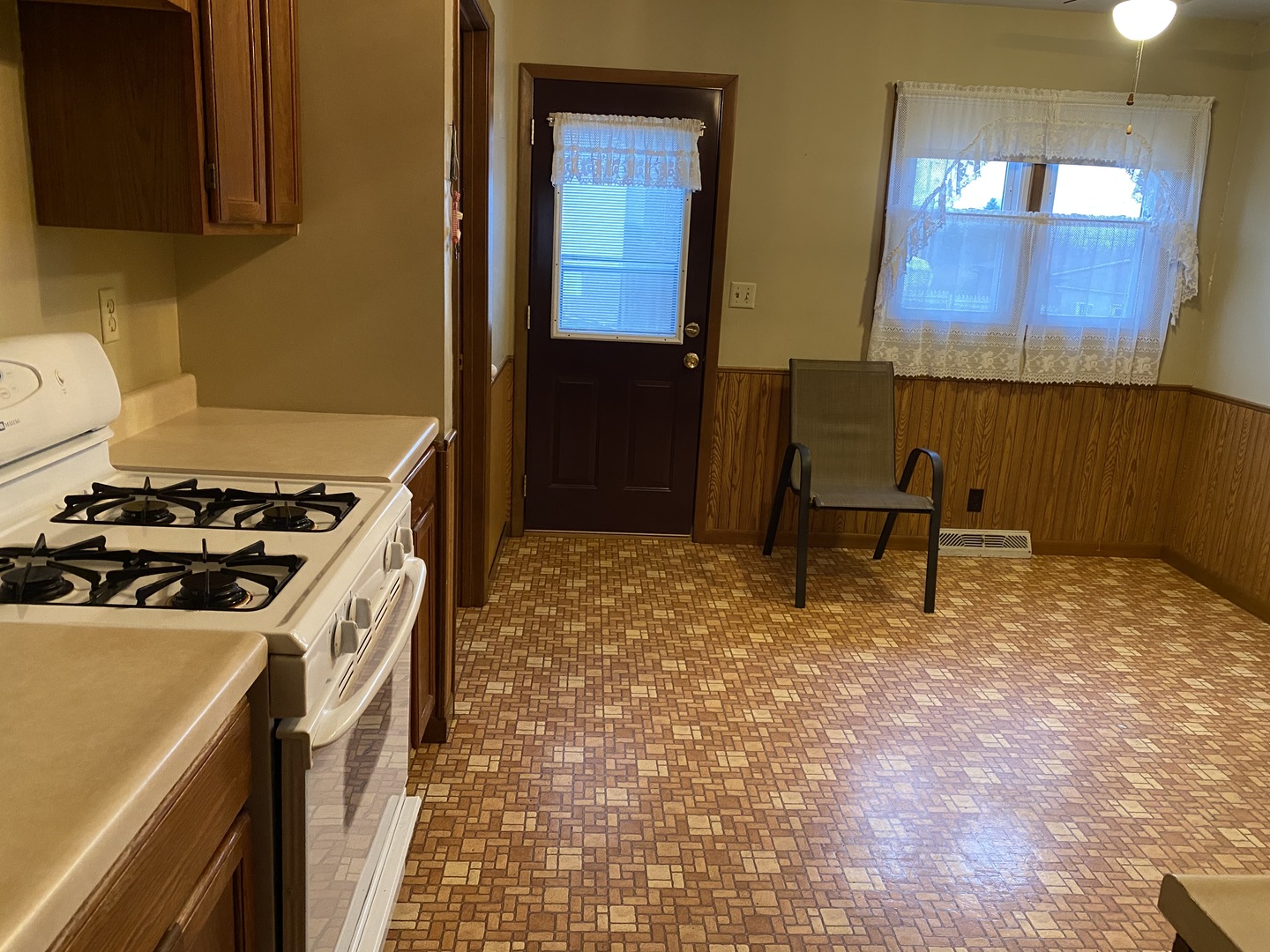 231 East Iowa Street Spring Valley, IL 61362 - Photo 5 of 13 a kitchen with a stove and a refrigerator