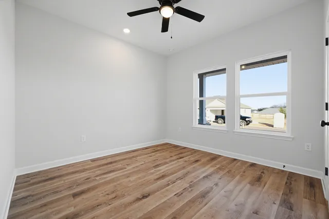 wooden floor in an empty room with a window