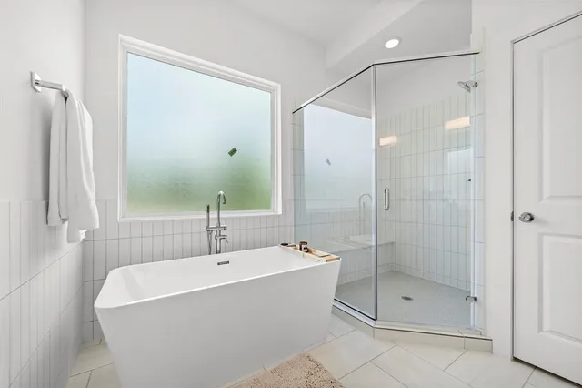 a white bath tub sitting next to a shower